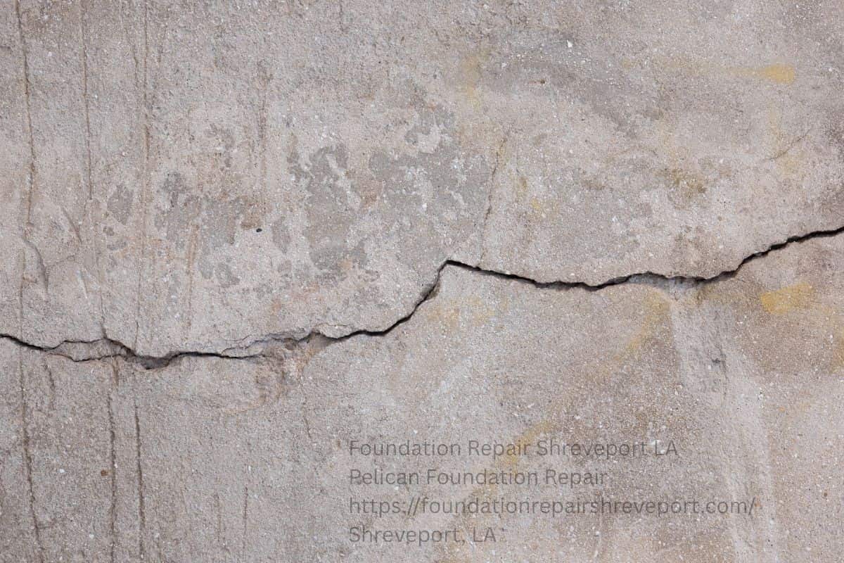 Bowing Basement Walls: Causes and Repair Options 1 Horizontal crack running across a concrete foundation wall, a classic sign of a bowing basement wall