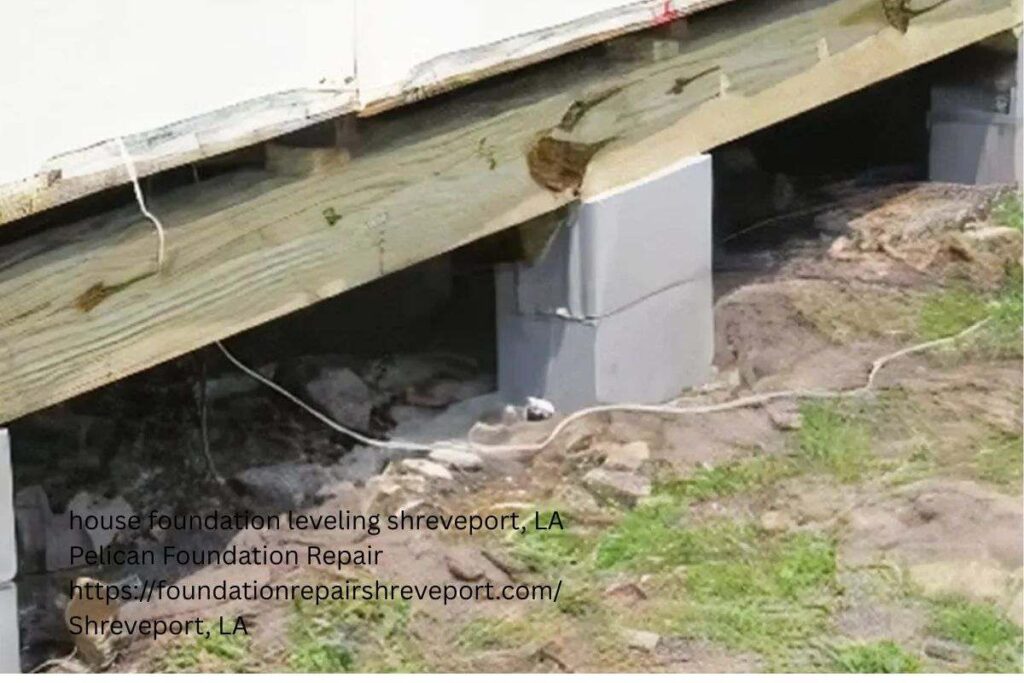 Wooden beam resting on a concrete block pier during house leveling